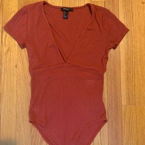 Dark orange bodysuit with low cut v-neck